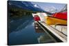 Glacier, Montana: Colorful Canoes Line the Dock at Many Glacier Lodge on Swiftcurrent Lake-Brad Beck-Stretched Canvas