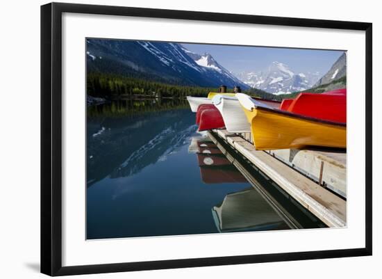 Glacier, Montana: Colorful Canoes Line the Dock at Many Glacier Lodge on Swiftcurrent Lake-Brad Beck-Framed Photographic Print