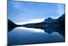 Glacier, Montana: Many Glacier Lodge Reflects Off of Swifcurrent Lake During Sunrise-Brad Beck-Mounted Photographic Print