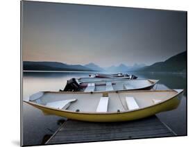 Glacier National Park- Boats Rest on a Dock in Front of Lake Mcdonald.-Ian Shive-Mounted Photographic Print