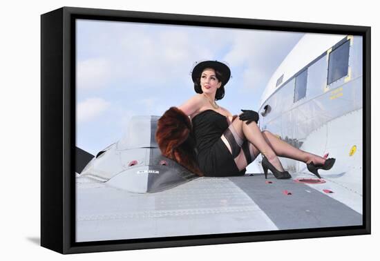 Glamorous Woman in 1940's Style Attire Sitting on a Vintage Aircraft-null-Framed Stretched Canvas