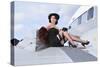 Glamorous Woman in 1940's Style Attire Sitting on a Vintage Aircraft-null-Stretched Canvas