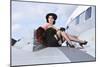 Glamorous Woman in 1940's Style Attire Sitting on a Vintage Aircraft-null-Mounted Photographic Print