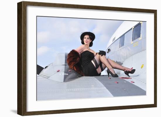 Glamorous Woman in 1940's Style Attire Sitting on a Vintage Aircraft-null-Framed Photographic Print