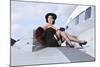 Glamorous Woman in 1940's Style Attire Sitting on a Vintage Aircraft-null-Mounted Photographic Print