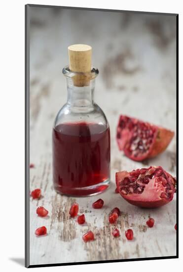 Glass Bottle with Pomegranate Juice and Pomegranate-Jana Ihle-Mounted Photographic Print