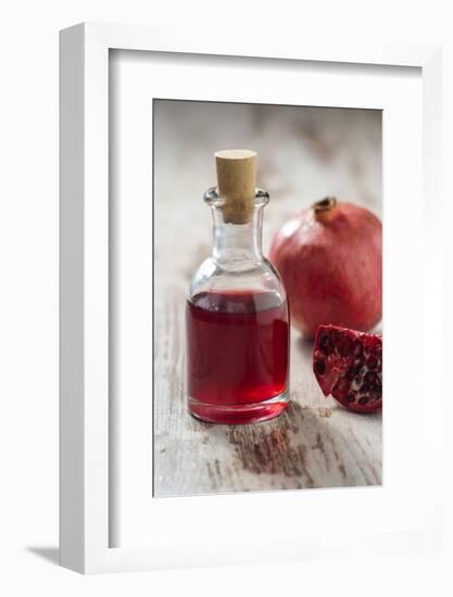 Glass Bottle with Pomegranate Juice and Pomegranate-Jana Ihle-Framed Photographic Print