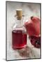 Glass Bottle with Pomegranate Juice and Pomegranate-Jana Ihle-Mounted Photographic Print