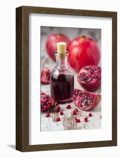 Glass Bottle with Pomegranate Juice and Pomegranates-Jana Ihle-Framed Photographic Print