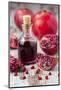 Glass Bottle with Pomegranate Juice and Pomegranates-Jana Ihle-Mounted Photographic Print