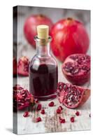 Glass Bottle with Pomegranate Juice and Pomegranates-Jana Ihle-Stretched Canvas