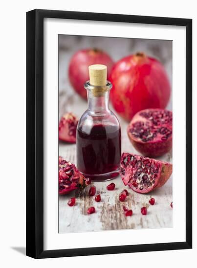 Glass Bottle with Pomegranate Juice and Pomegranates-Jana Ihle-Framed Photographic Print