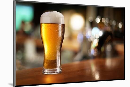 Glass of Light Beer on a Dark Pub.-Volff-Mounted Photographic Print