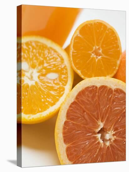 Glass of Orange Juice, Grapefruit and Oranges-null-Stretched Canvas