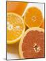 Glass of Orange Juice, Grapefruit and Oranges-null-Mounted Photographic Print