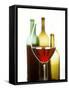 Glass of Red Wine in Front of Three Wine Bottles-Joerg Lehmann-Framed Stretched Canvas