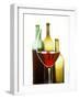 Glass of Red Wine in Front of Three Wine Bottles-Joerg Lehmann-Framed Photographic Print