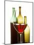 Glass of Red Wine in Front of Three Wine Bottles-Joerg Lehmann-Mounted Photographic Print