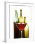 Glass of Red Wine in Front of Three Wine Bottles-Joerg Lehmann-Framed Photographic Print