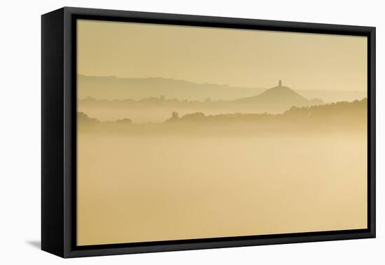 Glastonbury Tor and surrounding hills rising above early morning mist, Glastonbury, Somerset-Stuart Black-Framed Stretched Canvas