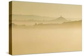 Glastonbury Tor and surrounding hills rising above early morning mist, Glastonbury, Somerset-Stuart Black-Stretched Canvas