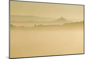Glastonbury Tor and surrounding hills rising above early morning mist, Glastonbury, Somerset-Stuart Black-Mounted Photographic Print