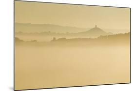 Glastonbury Tor and surrounding hills rising above early morning mist, Glastonbury, Somerset-Stuart Black-Mounted Photographic Print