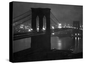 Glittering Night View of the Brooklyn Bridge Spanning the Glassy Waters of the East River-Andreas Feininger-Stretched Canvas