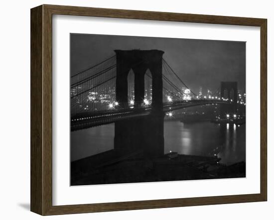 Glittering Night View of the Brooklyn Bridge Spanning the Glassy Waters of the East River-Andreas Feininger-Framed Photographic Print