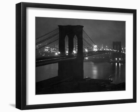 Glittering Night View of the Brooklyn Bridge Spanning the Glassy Waters of the East River-Andreas Feininger-Framed Photographic Print