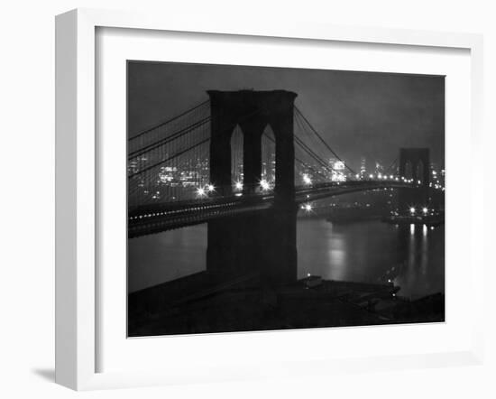 Glittering Night View of the Brooklyn Bridge Spanning the Glassy Waters of the East River-Andreas Feininger-Framed Photographic Print