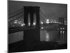Glittering Night View of the Brooklyn Bridge Spanning the Glassy Waters of the East River-Andreas Feininger-Mounted Photographic Print