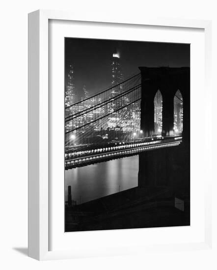 Glittering Night View of the Brooklyn Bridge Spanning the Glassy Waters of the East River-Andreas Feininger-Framed Photographic Print