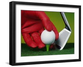 Gloved Hand Placing Golf Ball on Tee-null-Framed Photographic Print