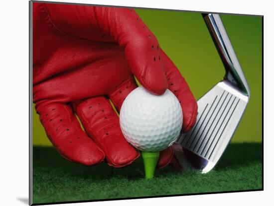 Gloved Hand Placing Golf Ball on Tee-null-Mounted Photographic Print