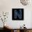 Glowing Letter N Isolated On Black Background-Andriy Zholudyev-Framed Stretched Canvas displayed on a wall