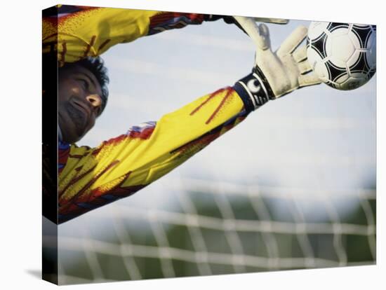 Goalie Attempting to Stop a Soccer Ball-null-Stretched Canvas