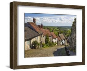 Gold Hill, cobbled lane lined with cottages and views over countryside, Shaftesbury, Dorset-Stuart Black-Framed Photographic Print