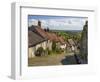 Gold Hill, cobbled lane lined with cottages and views over countryside, Shaftesbury, Dorset-Stuart Black-Framed Photographic Print