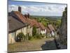 Gold Hill, cobbled lane lined with cottages and views over countryside, Shaftesbury, Dorset-Stuart Black-Mounted Premium Photographic Print