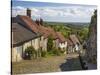 Gold Hill, cobbled lane lined with cottages and views over countryside, Shaftesbury, Dorset-Stuart Black-Stretched Canvas