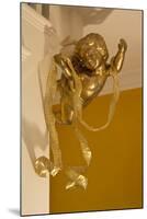 Gold Ribbon Trailing over Cherub Figure in Corner of Room-Richard Bryant-Mounted Photo