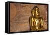 Golden Buddha Statue in Front of Burmese Writing on Wall, Bagan, Myanmar-Harry Marx-Framed Stretched Canvas