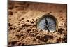 Golden Compass Buried in the Sand Concept for Lost or Direction-Flynt-Mounted Photographic Print