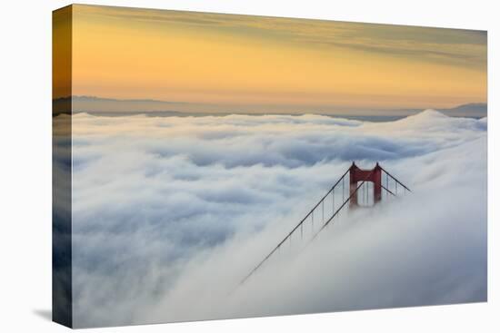 Golden Gate Bridge emerging from the morning fog at sunrise. San Francisco, Marin County, Californi-ClickAlps-Stretched Canvas