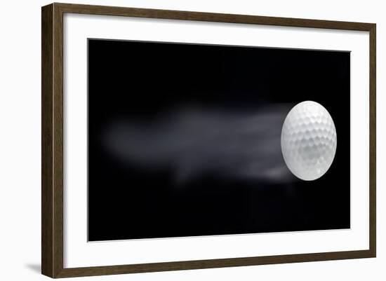 Golf Ball Leaving Trails Behind On Black Background-null-Framed Art Print