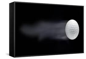 Golf Ball Leaving Trails Behind On Black Background-null-Framed Stretched Canvas