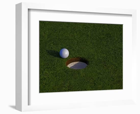 Golf Ball Sitting Near the Hole-null-Framed Photographic Print