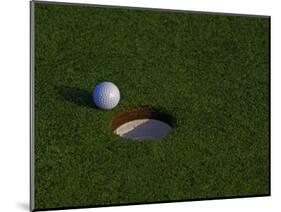 Golf Ball Sitting Near the Hole-null-Mounted Photographic Print