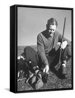 Golfer Byron Nelson Cleaning the Cleats on His Shoes-Gabriel Benzur-Framed Stretched Canvas